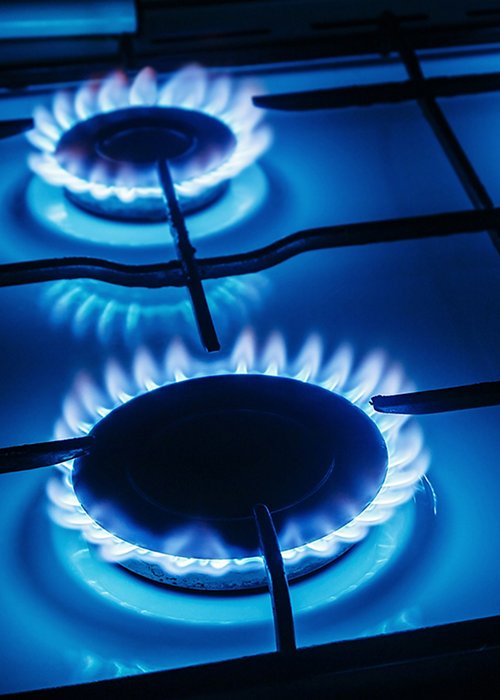 Blue flames of gas burning from a kitchen gas stove 
