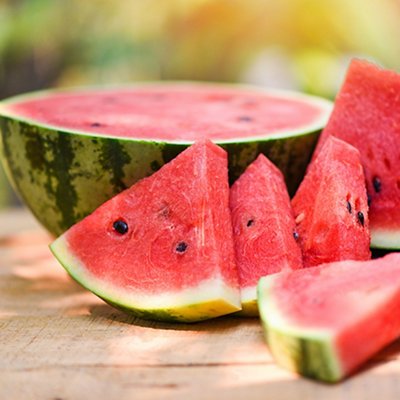 Sliced watermelon on wooden and nature background - Close up fresh watermelon pieces tropical summer fruit 