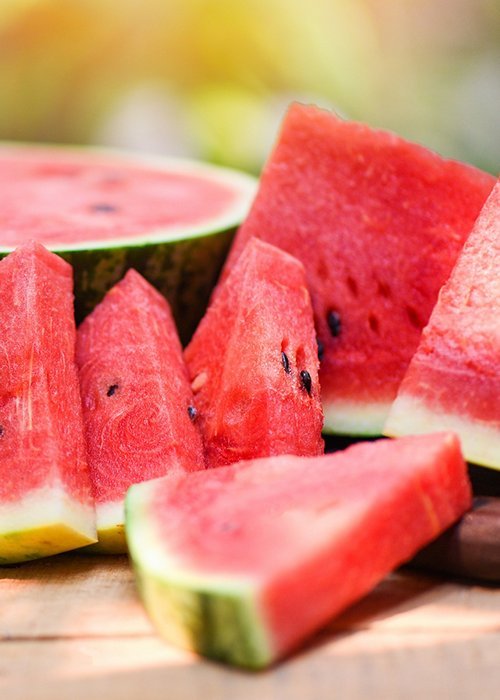 Sliced watermelon on wooden and nature background - Close up fresh watermelon pieces tropical summer fruit 