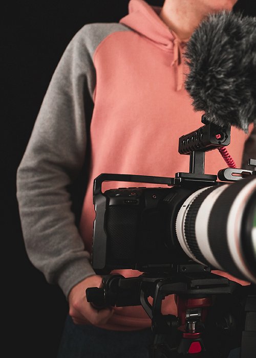 Filmmaker or cinematographer shooting with a professional camera cinematic videos. Documentaries, movies and TV series cameraman.