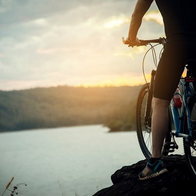 Cyclist Man Racing Bike on Mountain