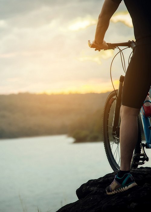 Cyclist Man Racing Bike on Mountain