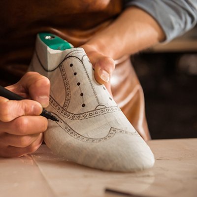 Close up of a male shoemaker drawing design