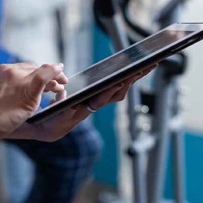 Close up of medical assistant touching tablet display