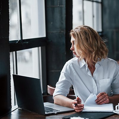 Want to have a walk on the street. Businesswoman with curly blonde hair indoors in cafe at daytime, Want to have a walk on the street. Businesswoman with curly blonde hair indoors in cafe at daytime