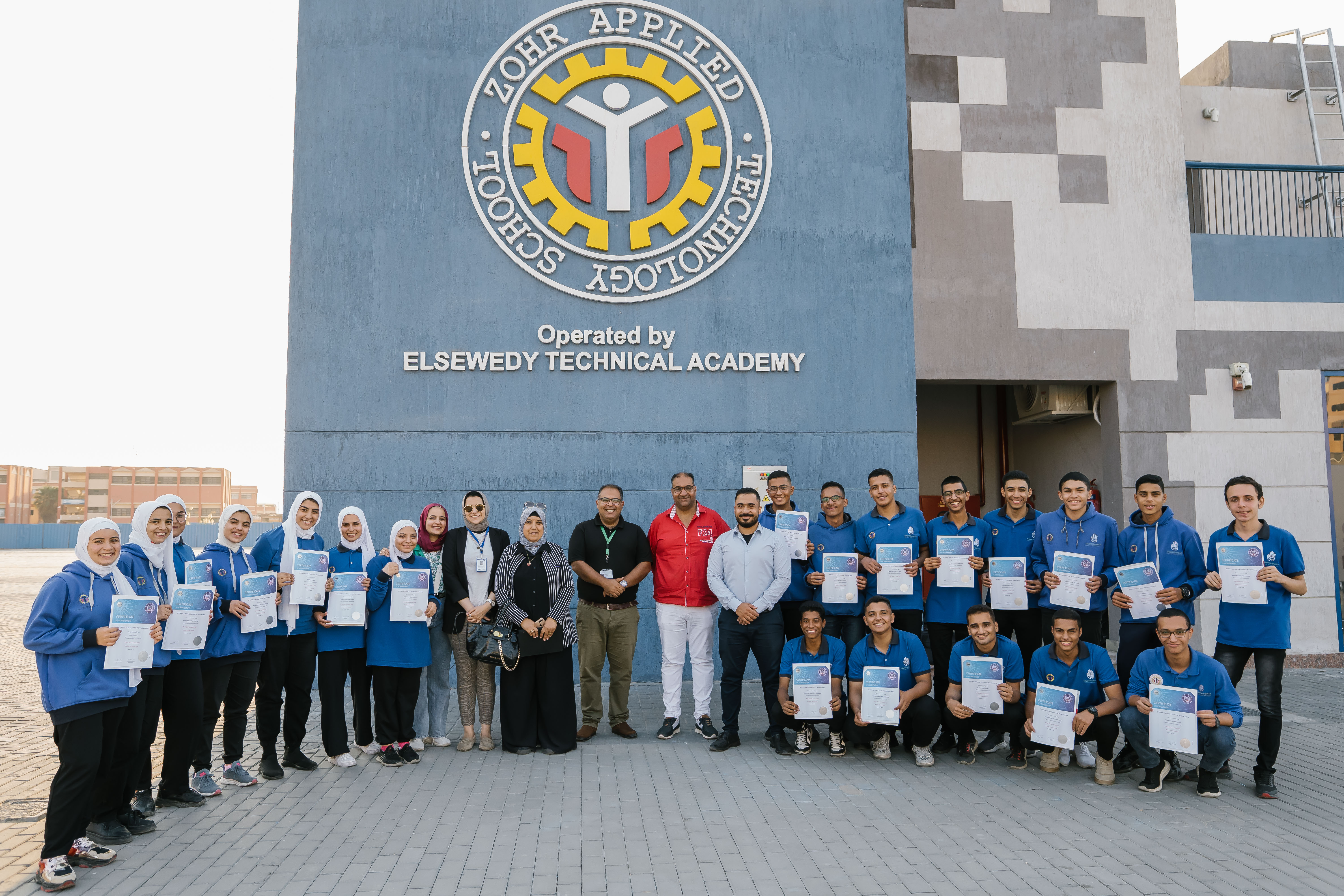 Group of students in front of the school