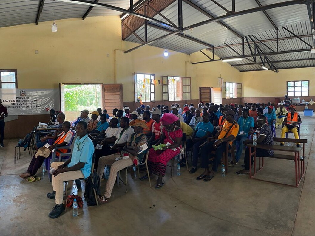 A group of people listen to a presentation in a classroom